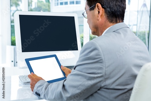 Businessman looking at his tablet 