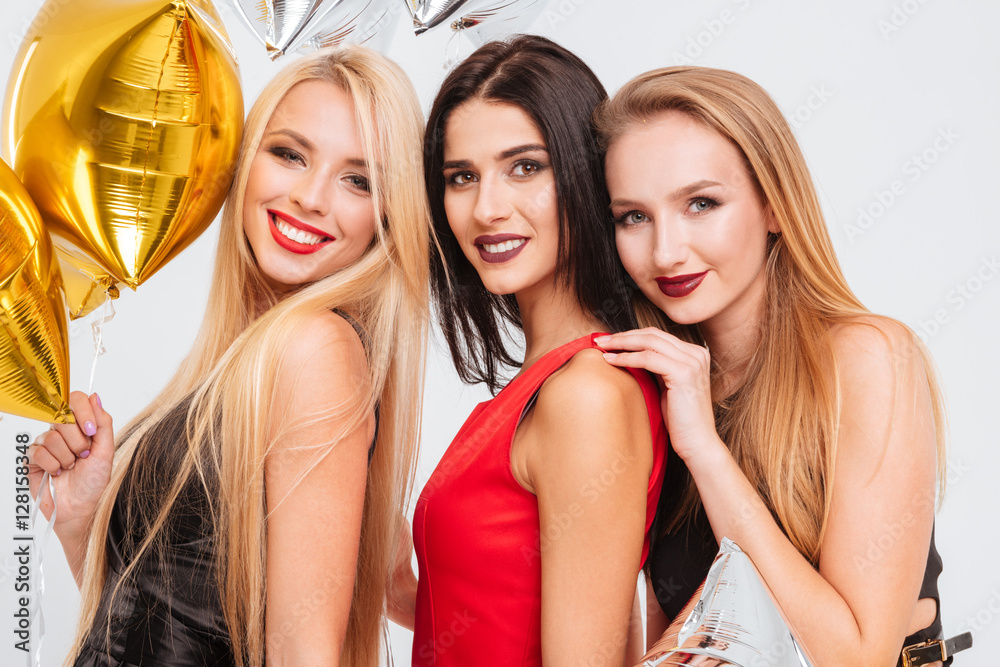Portrait of three happy young women with star shaped balloons Portrait of three happy young women with star shaped balloons