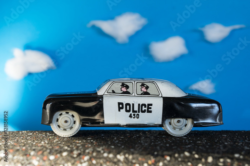 Police toy car on blue background