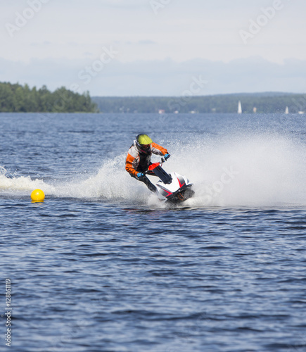 Water jet ski running fast in the water and splashing. Also known as personal water craft. 