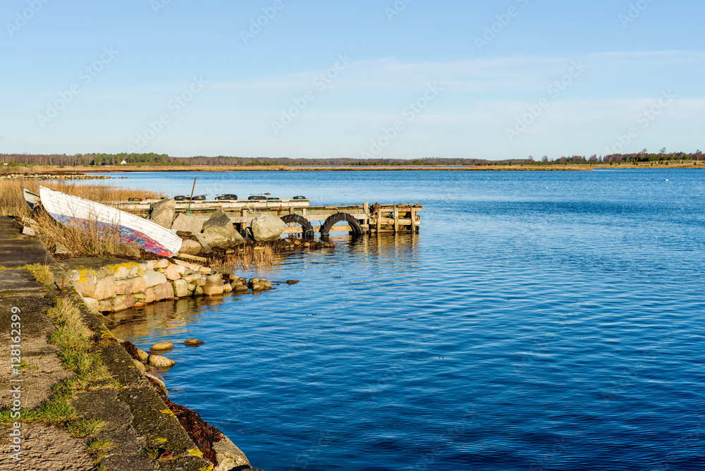 Pulled up wooden rowboats in coastal landscape in fall. Kristianopel in Sweden. Pulled up wooden rowboats in coastal landscape in fall. Kristianopel in Sweden.