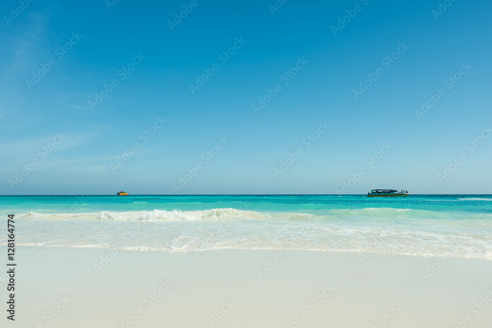 Beautiful gentle wave at the tropical beach with blue sky