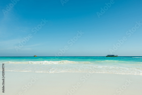 Beautiful gentle wave at the tropical beach with blue sky © peangdao