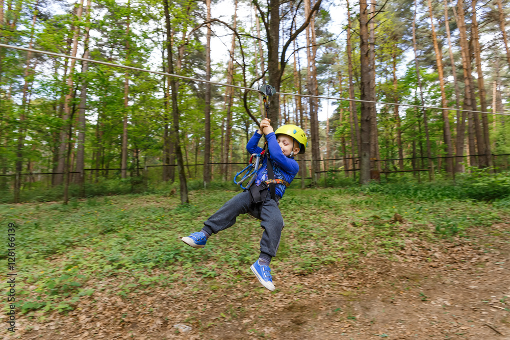 Little boy in climbing gear