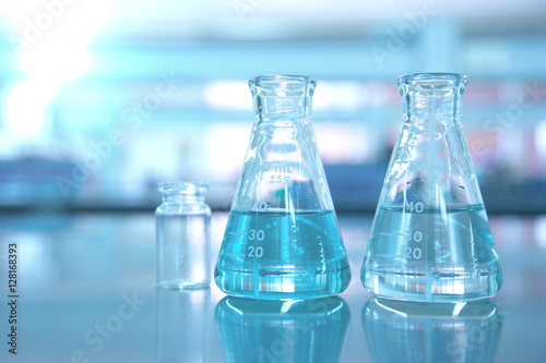 blue glass flask in science lab background