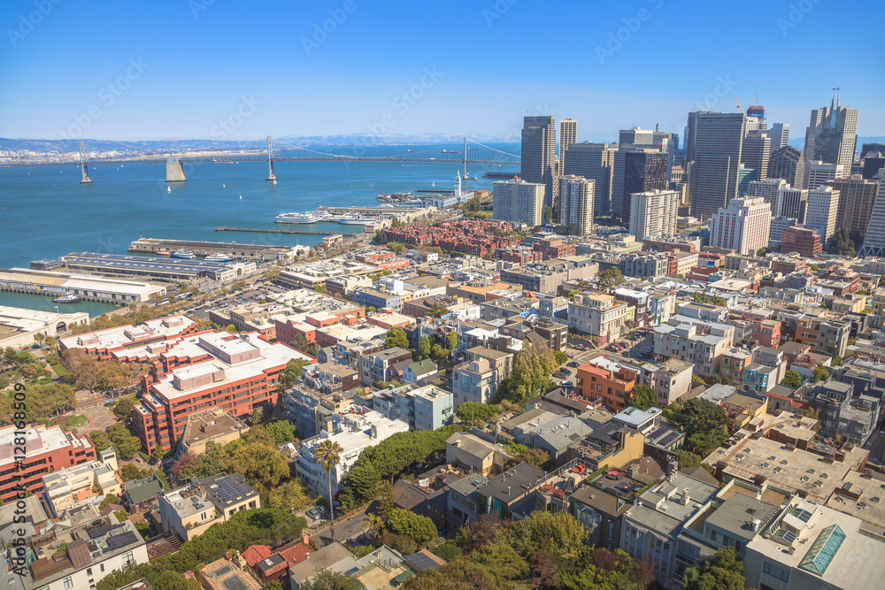 Aerial panorama of San Francisco Financial District, Embarcadero and Oakland Bridge, from top of Coit Tower on sunny day, California, United States.