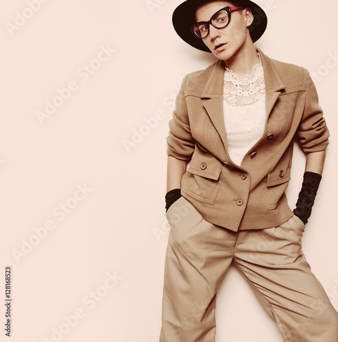 Vintage Fashion Woman Beige classic suit and stylish eyewear. Bl photo