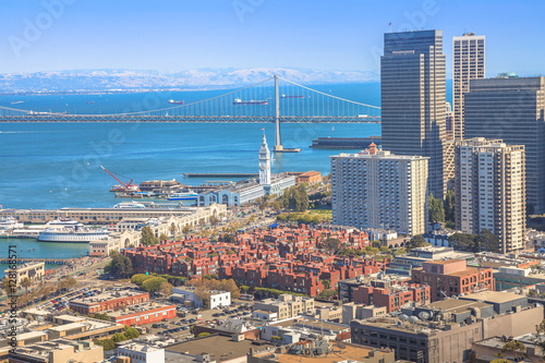 Aerial view close up of San Francisco skycraper, Embarcadero and Oakland Bridge from top of Coit Tower on Telegraph Hill on a sunny day. California, United States.