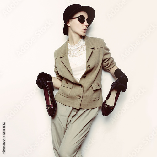 Vintage Fashion Woman. Beige classic costume and stylish Accesso photo