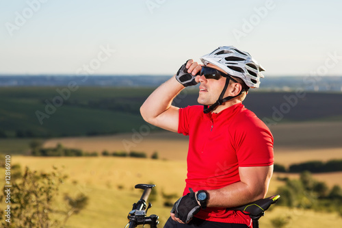 Portrait of Young Cyclist in Helmet and Glasses