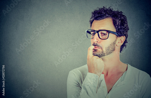 Closeup perplexed preoccupied young man