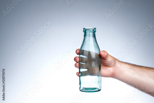 Hand holding old-school milk bottle