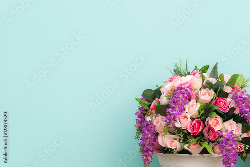 colorful of rose in flowerpot on pastel cement wall