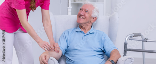 Nurse connecting drip to senior photo