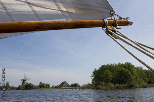 Sailing at frisian lakes. Sailing at the lake. Windmill near the lake of  Langweer. Langwarder Wieden. Friesland Netherlands. 