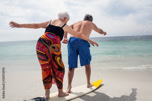 Photography Senior couple surfing on beach