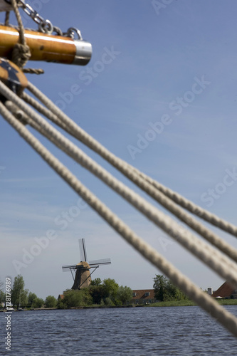 Sailing at the lake. Windmill near the lake of  Langweer. Langwarder Wieden. Friesland Netherlands. Rope. photo