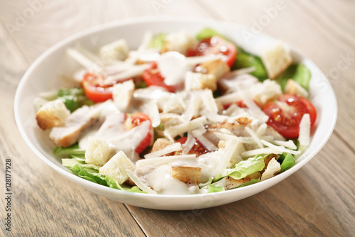caesar salad with red cherry tomatoes, shallow focus