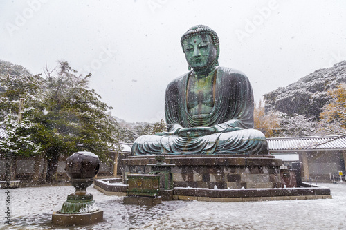 The Great Buddha in Kamakura.It's snowing.  Located in Kamakura, Kanagawa Prefecture Japan.