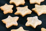 Baked star shaped cookies pattern on the black table