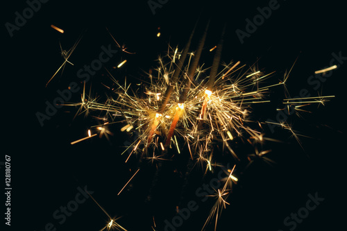 Party Sparkler on Dark Background. Holiday Fireworks on Black. New Year Eve or Christmas