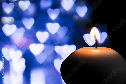 Candle on bokeh hearts background. Vintage style. 