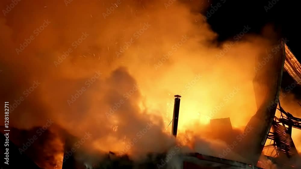 House building on fire at night. Blaze Inferno conflagration and combustion.