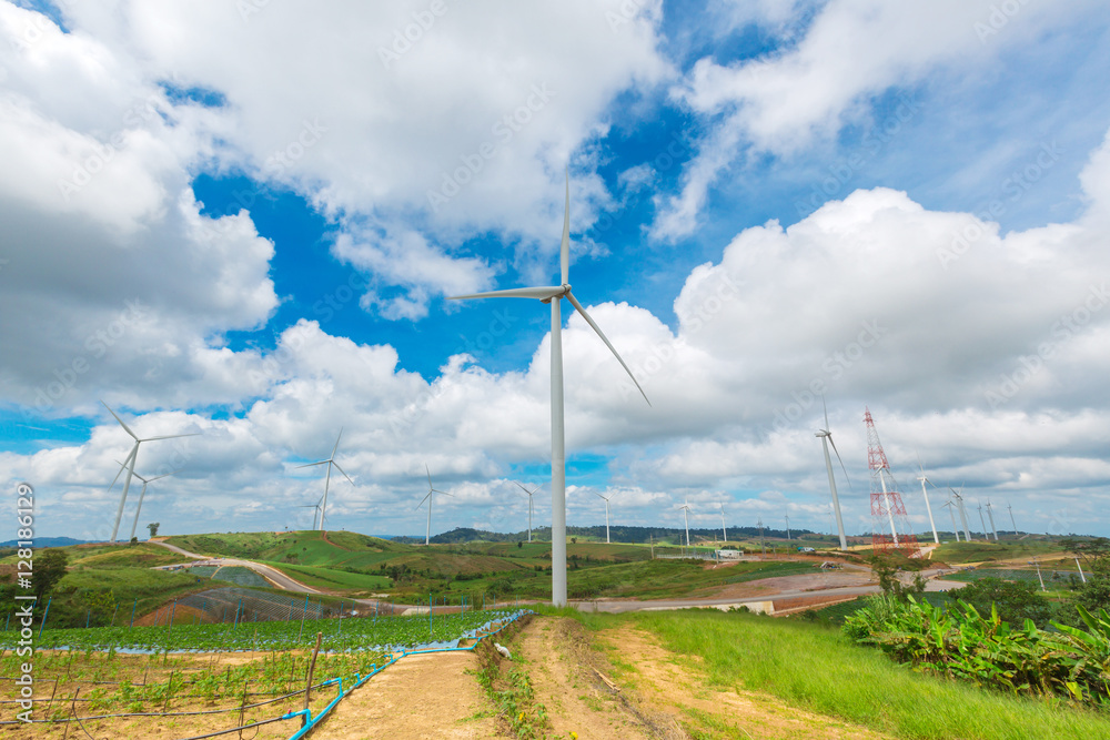 Obraz premium Huge wind turbine under clouds and blue sky, beautiful nature and Renewable power background