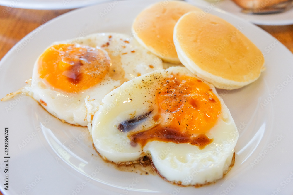 Fried Egg sprinkle with soy sauce and pepper with Pancake serve Fried Egg sprinkle with soy sauce and pepper with Pancake serve