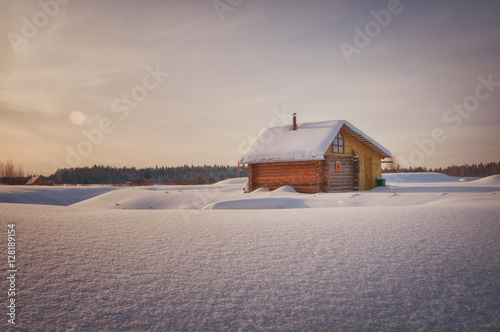 russian rural house in the winter covered with snow