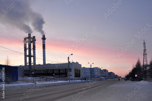 Pipes of the Steamshop or Boiler-house on the city street in the frosty evening. North photo