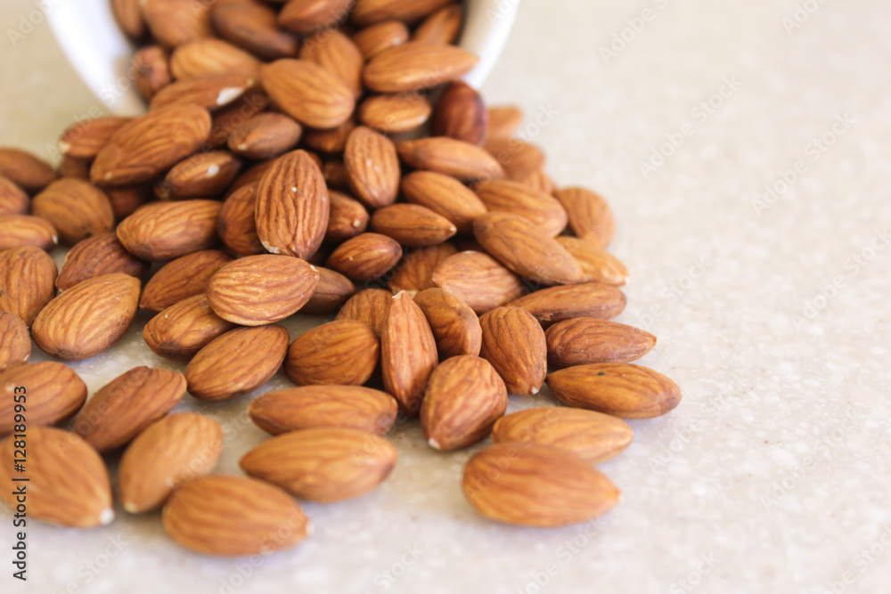 Almonds Spilling Out Of Container, Positioned Close Off Left Edg Almonds Spilling Out Of Container, Positioned Close Off Left Edg
