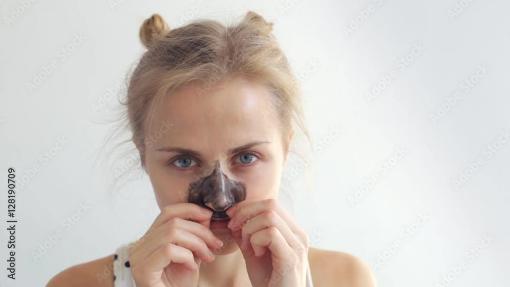 Woman removing her black mask Woman removing her black mask