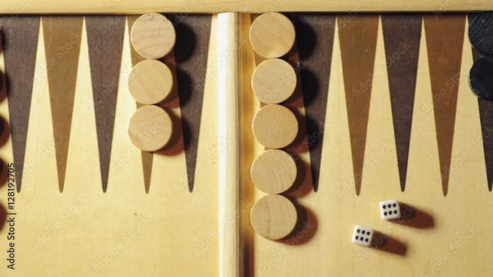 Backgammon board with rolling dice, double six, shot from above.