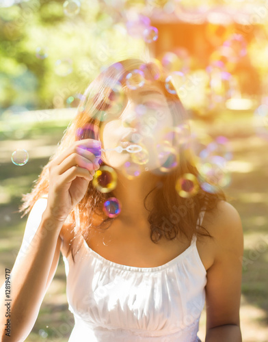a beautiful woman blowing bubbles