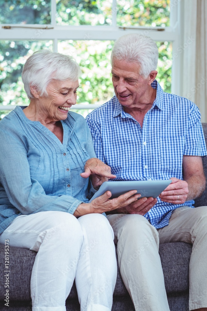 Smiling senior couple using tablet Smiling senior couple using tablet