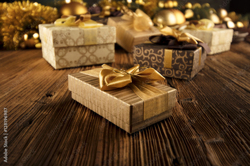 Golden Christmas decoration. Presents in boxes on a wooden background with copy space. Golden baubles. Christmas theme. Golden and brownish aesthetics. Christmas spices. Golden Christmas decoration. Presents in boxes on a wooden background with copy space. Golden baubles. Christmas theme. Golden and brownish aesthetics. Christmas spices.