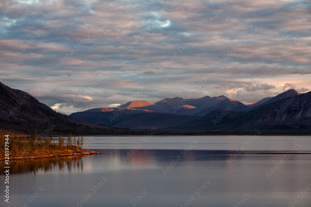 Mountain lake and sky in the sunset light. Lake Labynkyr. Oimyakon Highlands. Yakutia. Russia.