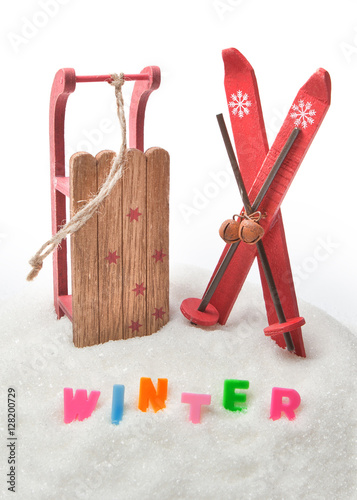 Wooden toy sled with skis and the words 