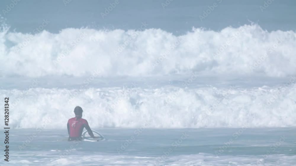 Estoril, Portugal - July 15, 2016: Surfers riding waves on July 15, 2016 in Estoril, Portugal. Powerful nature, active lifestyle and people Estoril, Portugal - July 15, 2016: Surfers riding waves on July 15, 2016 in Estoril, Portugal. Powerful nature, active lifestyle and people