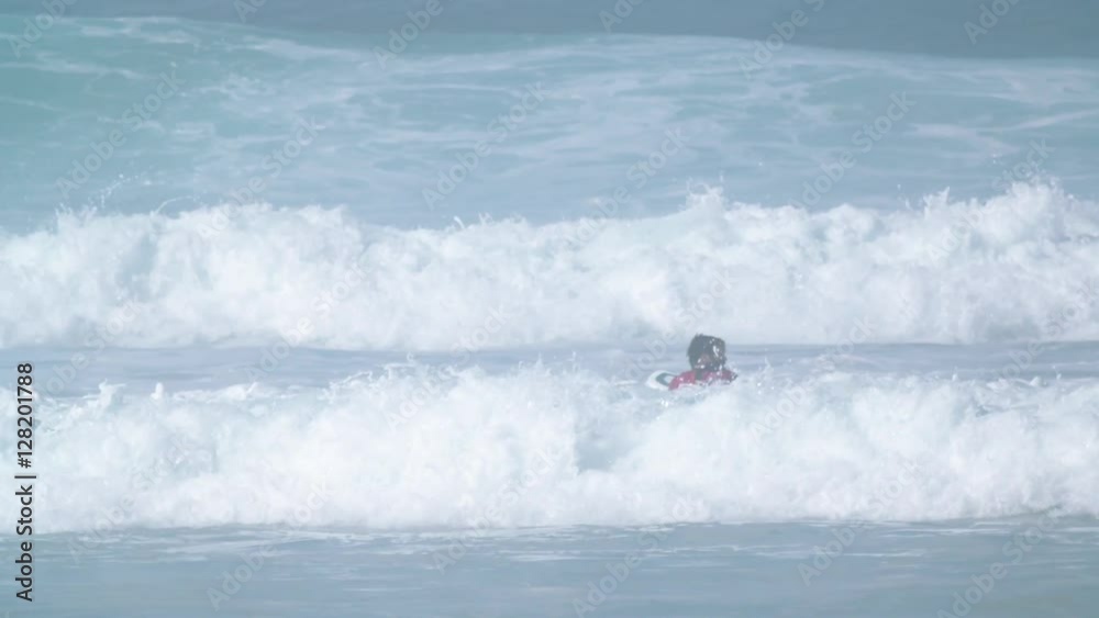 Estoril, Portugal - July 15, 2016: Surfers riding waves on July 15, 2016 in Estoril, Portugal. Powerful nature, active lifestyle and people Estoril, Portugal - July 15, 2016: Surfers riding waves on July 15, 2016 in Estoril, Portugal. Powerful nature, active lifestyle and people