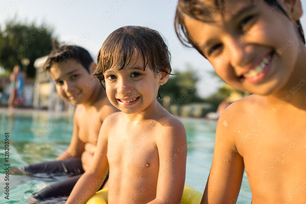 Young boy kid child splashing in swimming pool having fun leisur Young boy kid child splashing in swimming pool having fun leisur