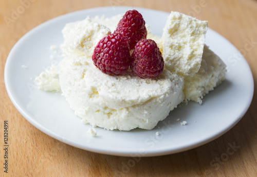 Cottage cheese in plate with berries