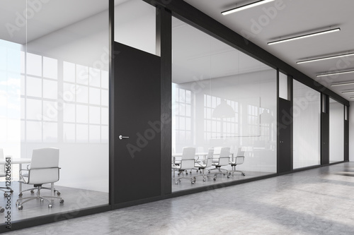 Long office corridor with a row of conference rooms