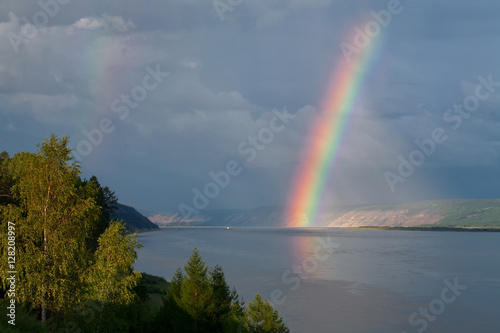The bright rainbow over the big river. Lena river. Yakutia. Russia.