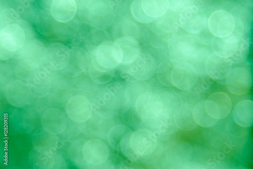 Green bokeh background created by neon lights.