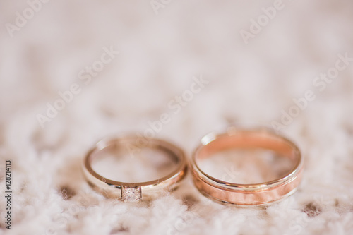 wedding rings on white knitted background