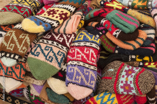 Group of handmade colorful knitted socks in the market