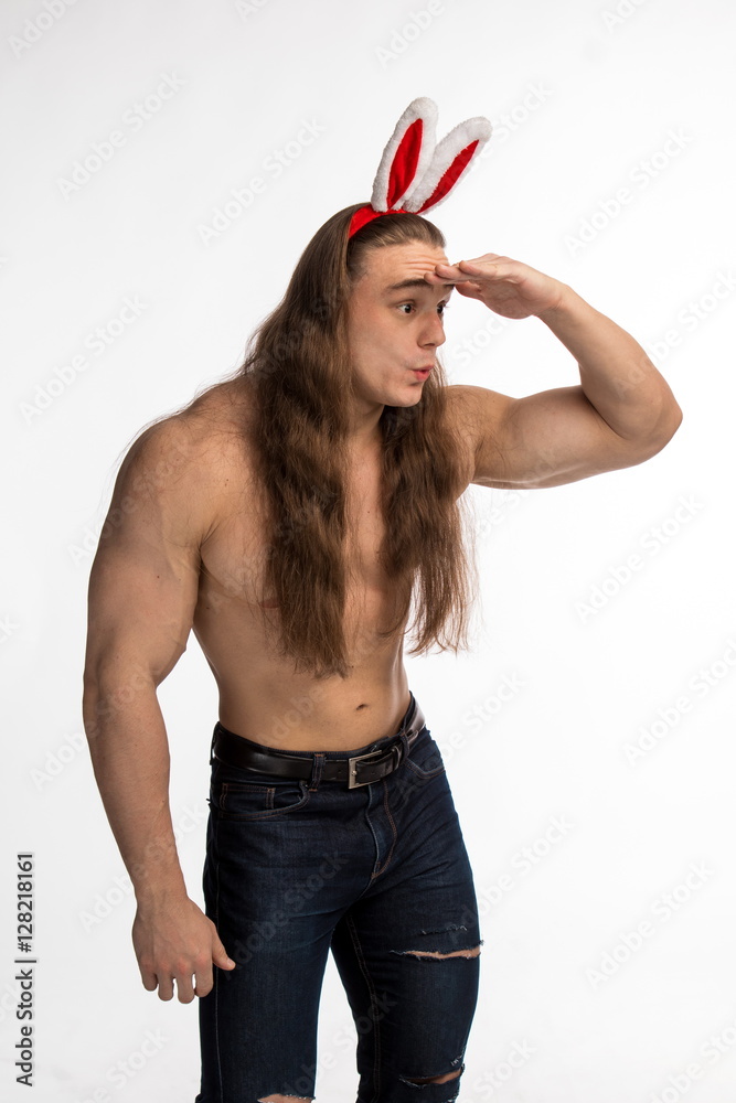 athlete bodybuilder shirtless with long hair posing with a rabbit-like ...