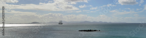 Ocean Panorama Square Rigged Tall Ship with the Northern Coast of Fuerteventura and the Island of Lobos in the Background. © harlequin9